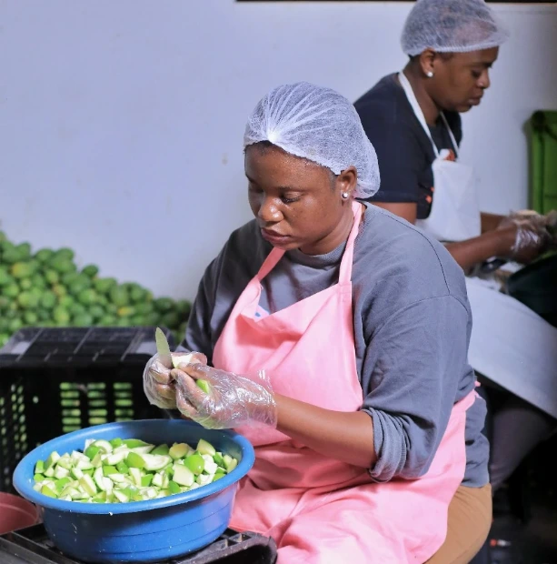 Oumie's Grande team preparing fresh mangoes by hand